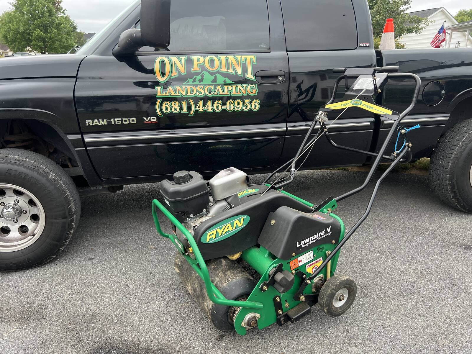 Lawn aerator parked beside the On Point Landscaping truck