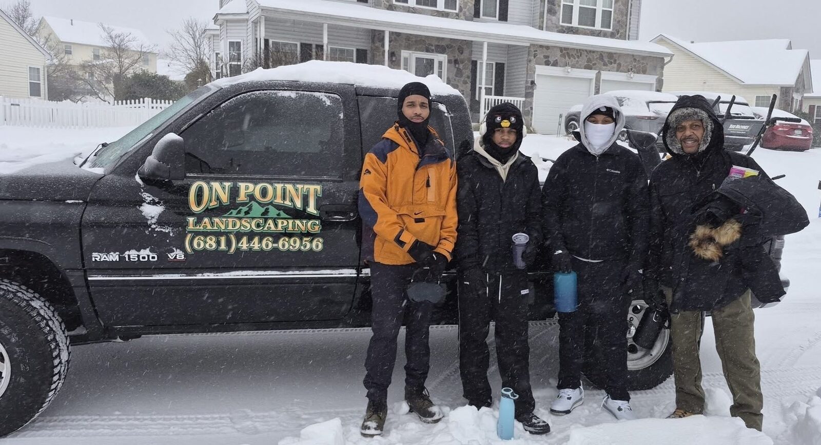 The On Point Landscaping crew beside their truck during winter snow removal work
